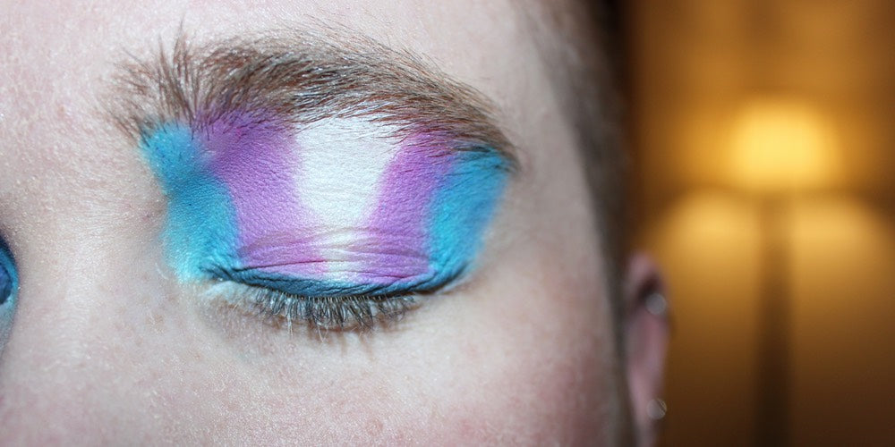 Eye shadow in the colours of the trans pride flag: blue, pink and white