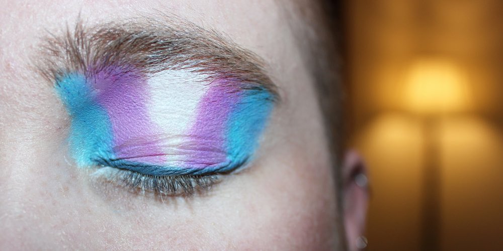 Eye shadow in the colours of the trans pride flag: blue, pink and white