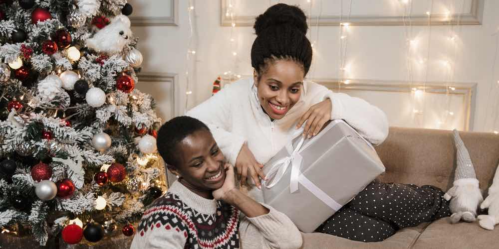 Two women opening presents at christmas