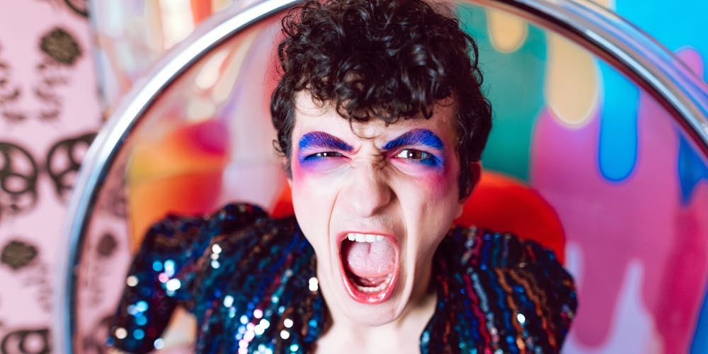 A person wearing sequins with blue and pink eye shadow