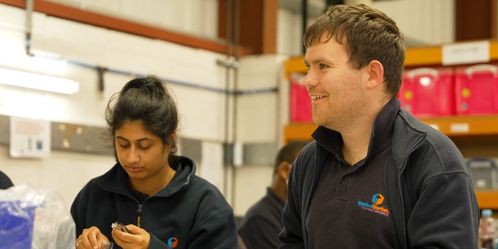 Two people working in a factory for Watford Workshop
