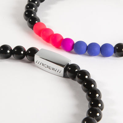 Close-up of bisexual pride bracelet showing pink, purple and blue beads and RCREW clasp, 6mm