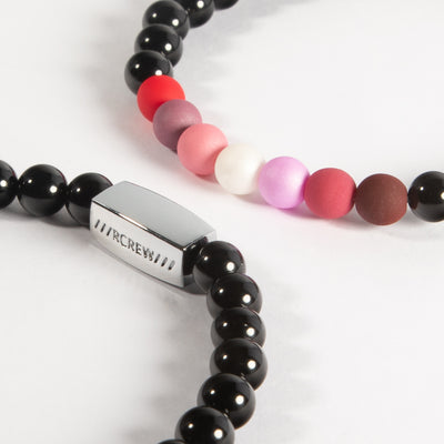 Close-up of lesbian pride bracelet showing red, pink and white beads and RCREW clasp, 6mm