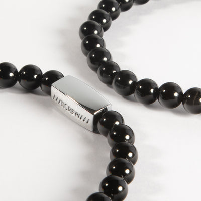 Close-up of black agate semi-precious bracelet showing natural black gemstone beads and RCREW clasp, 6mm