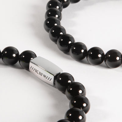 Close-up of black agate semi-precious bracelet showing natural black gemstone beads and RCREW clasp, 8mm