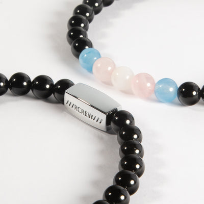 Close-up of trans pride semi-precious bracelet showing light blue, pink and white gemstone beads and RCREW clasp, 6mm