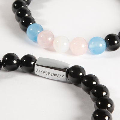 Close-up of trans pride semi-precious bracelet showing light blue, pink and white gemstone beads and RCREW clasp, 8mm