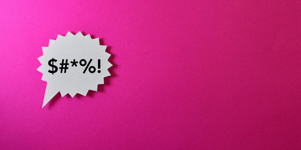 A pink background with a white speech bubble expleting: $#*%!