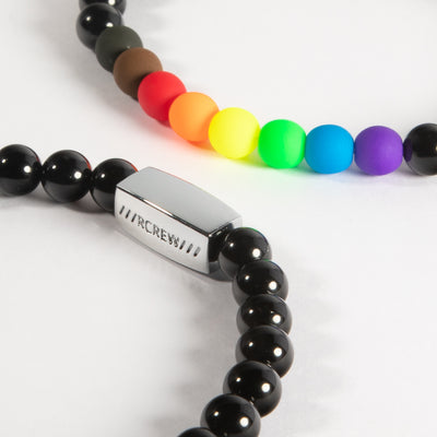 Close-up of diversity pride bracelet showing rainbow, black and brown beads and RCREW clasp, 6mm