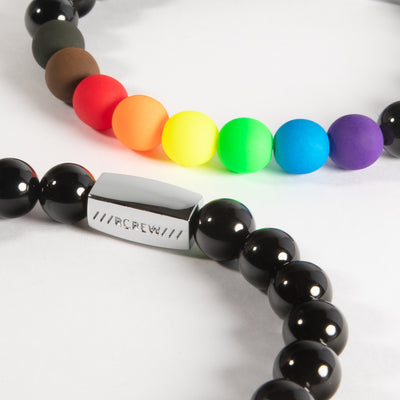 Close-up of diversity pride bracelet showing rainbow, black and brown beads and RCREW clasp, 8mm