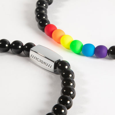 Two bold gay pride bracelets stacked together showing rainbow beads, 6mm