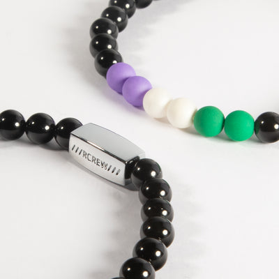Close-up of genderqueer pride bracelet showing lavender, white and green beads and RCREW clasp, 6mm