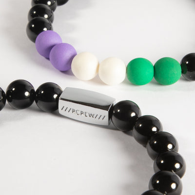 Close-up of genderqueer pride bracelet showing lavender, white and green beads and RCREW clasp, 8mm