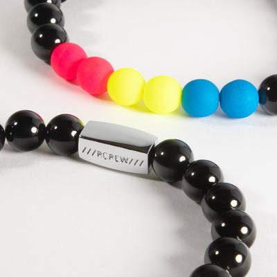 Close-up of pansexual pride bracelet showing pink, yellow and cyan blue beads and RCREW clasp, 8mm