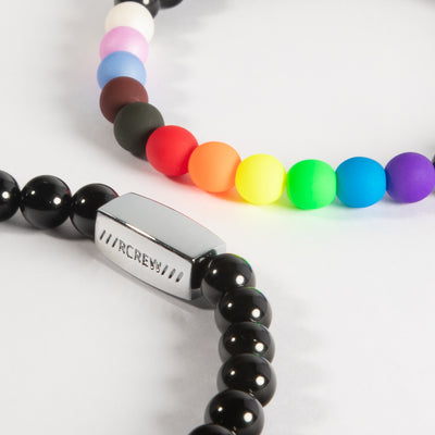 Close-up of progress pride bracelet showing progress flag colours and RCREW clasp, 6mm