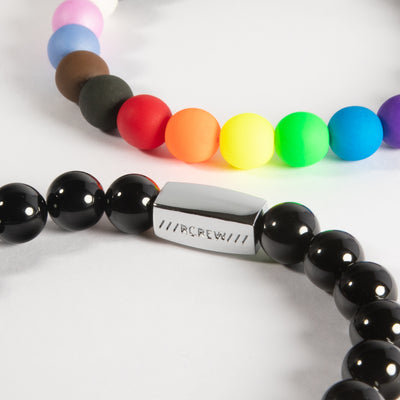 Close-up of progress pride bracelet showing progress flag colours and RCREW clasp, 8mm