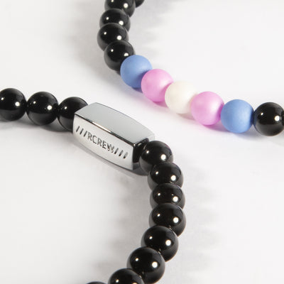 Close-up of trans pride bracelet showing light blue, pink and white beads and RCREW clasp, 6mm