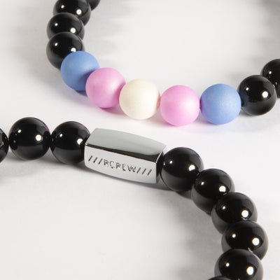 Close-up of trans pride bracelet showing light blue, pink and white beads and RCREW clasp, 8mm