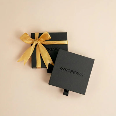 Black gift box with gold ribbon and 'RCREW' branding