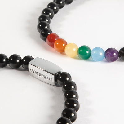 Close-up of gay pride semi-precious bracelet showing rainbow gemstone beads and RCREW clasp, 6mm